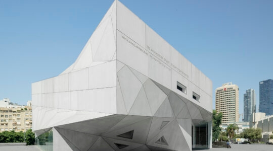 The museum building has a white, Origami-like design and contemporary architectural style.