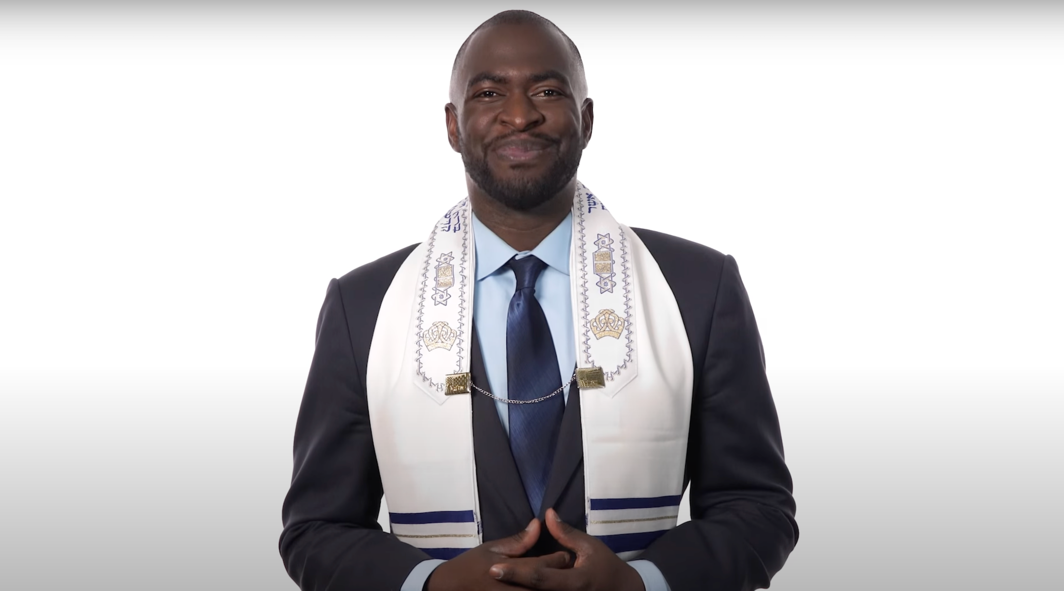 A man in a tallit on a white background